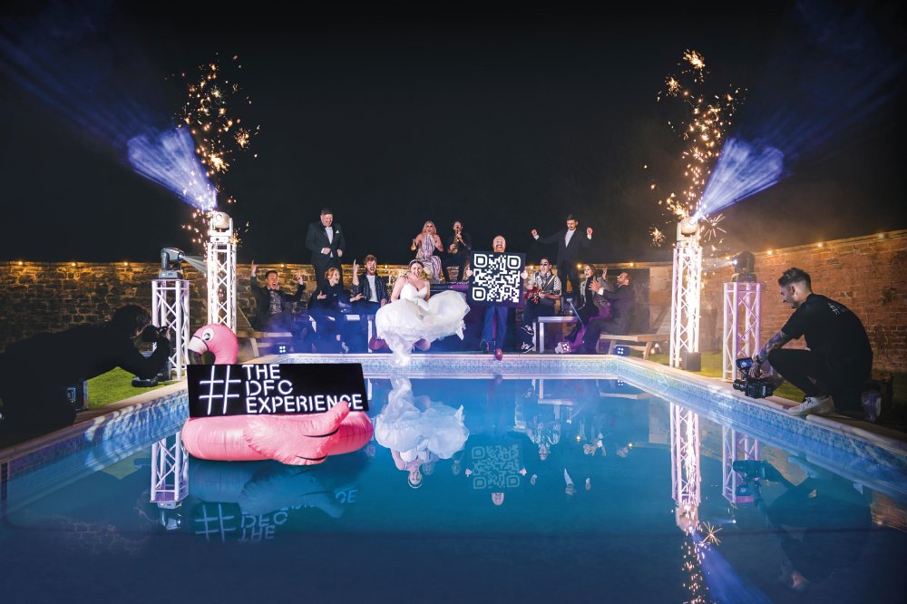 The DFC team celebrating around a pool