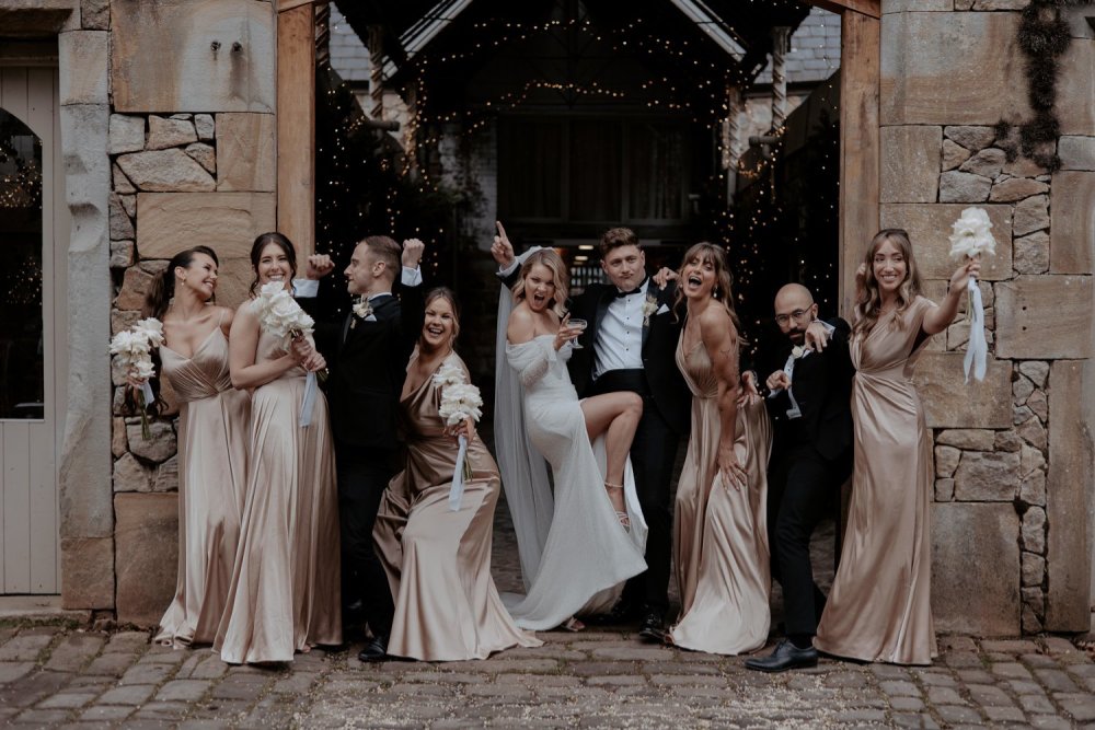 A newlywed couple & their family posing for a photo