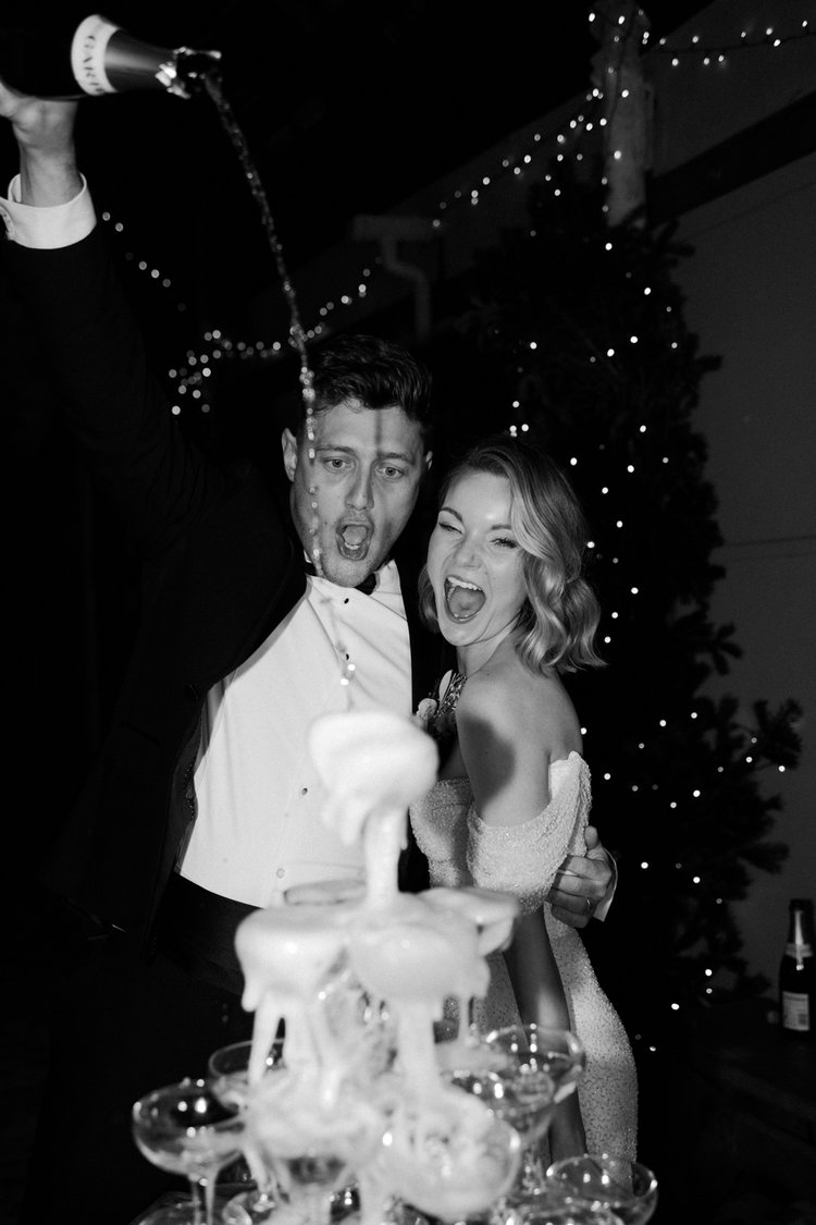 A couple pouring champagne