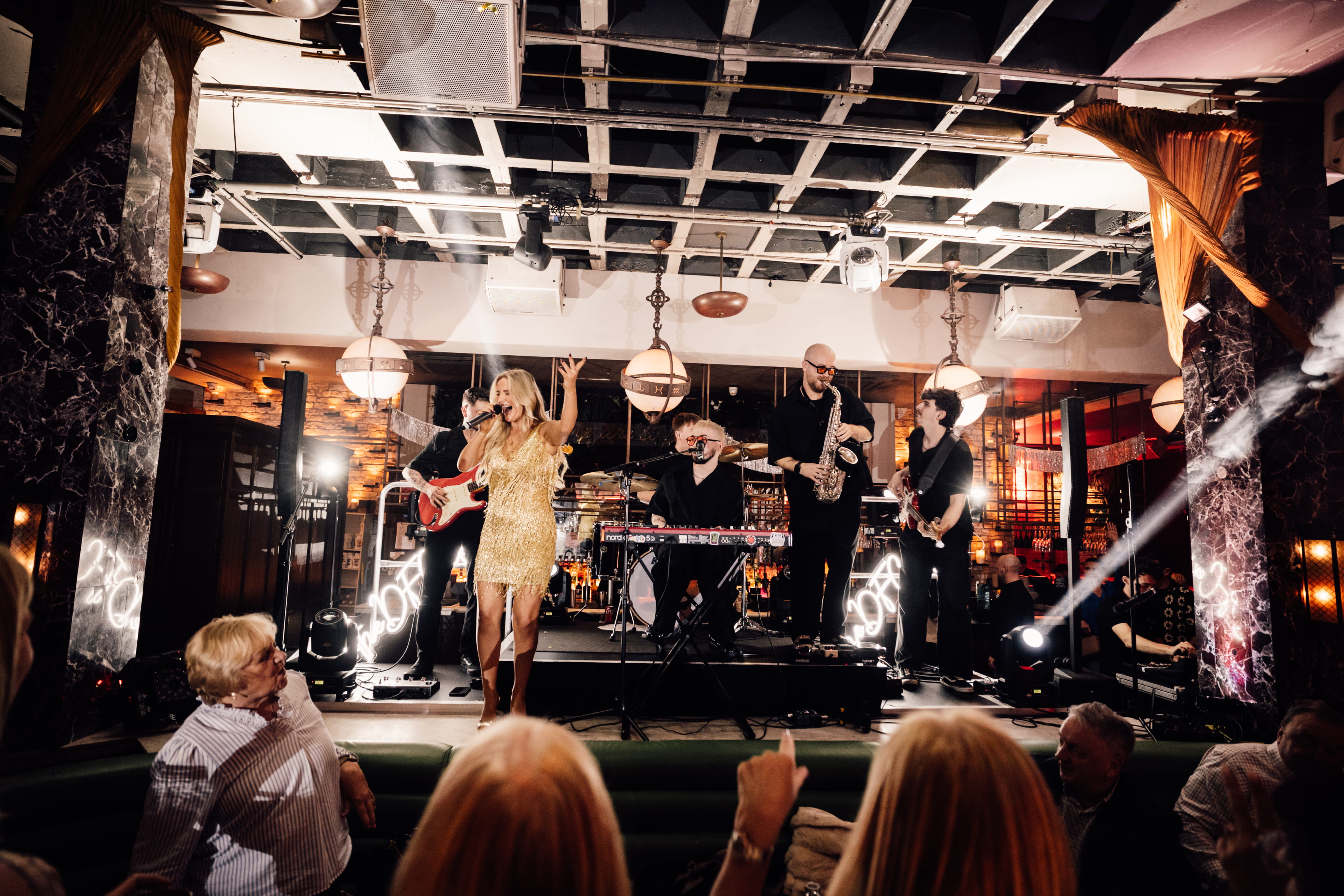 A woman singing into a microphone at a wedding